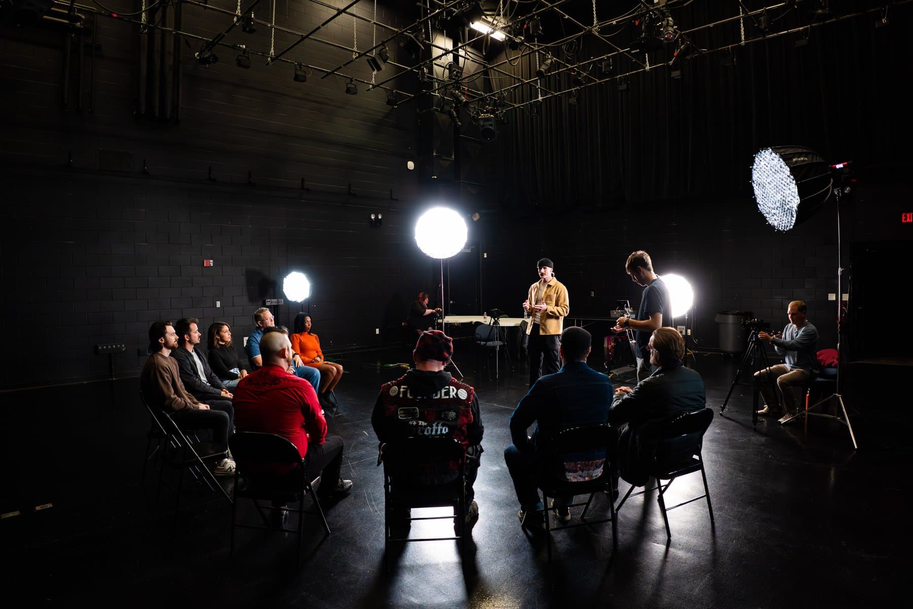 Wide shot of the Counterpoint studio during filming, showing the full panel, host, and lighting rig